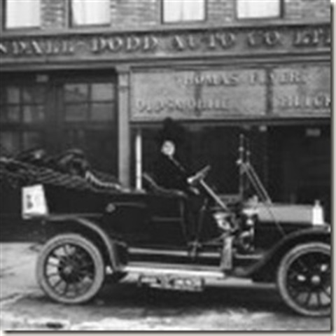 A black and white image of an early automobile.