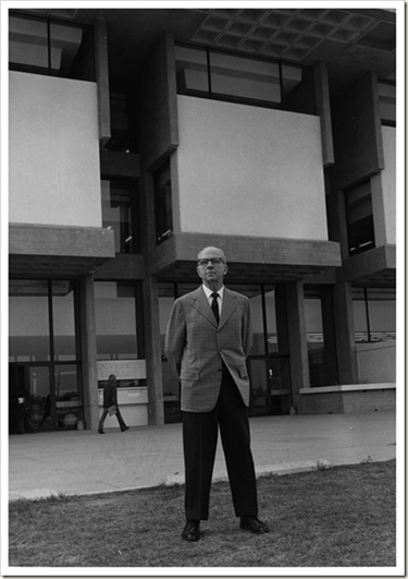 Black and white picture of a man standing infront of the UNC Library.
