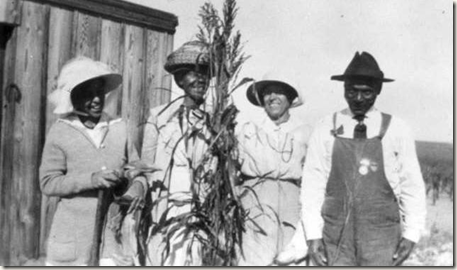 Four people with wheat and corn