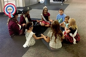 2017 Fair Royalty Queen, Lindsey Leafgren and Attendant, Madison LaBorde, teach Weld County children how to be royalty for a day at last year’s fair.