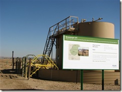 A picture of the Grenemeyer #1 Well with a sign in the foreground. 