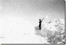Man shoveling a large amount of snow