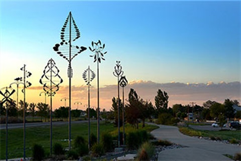 Sculptures along the side of the road at sunset